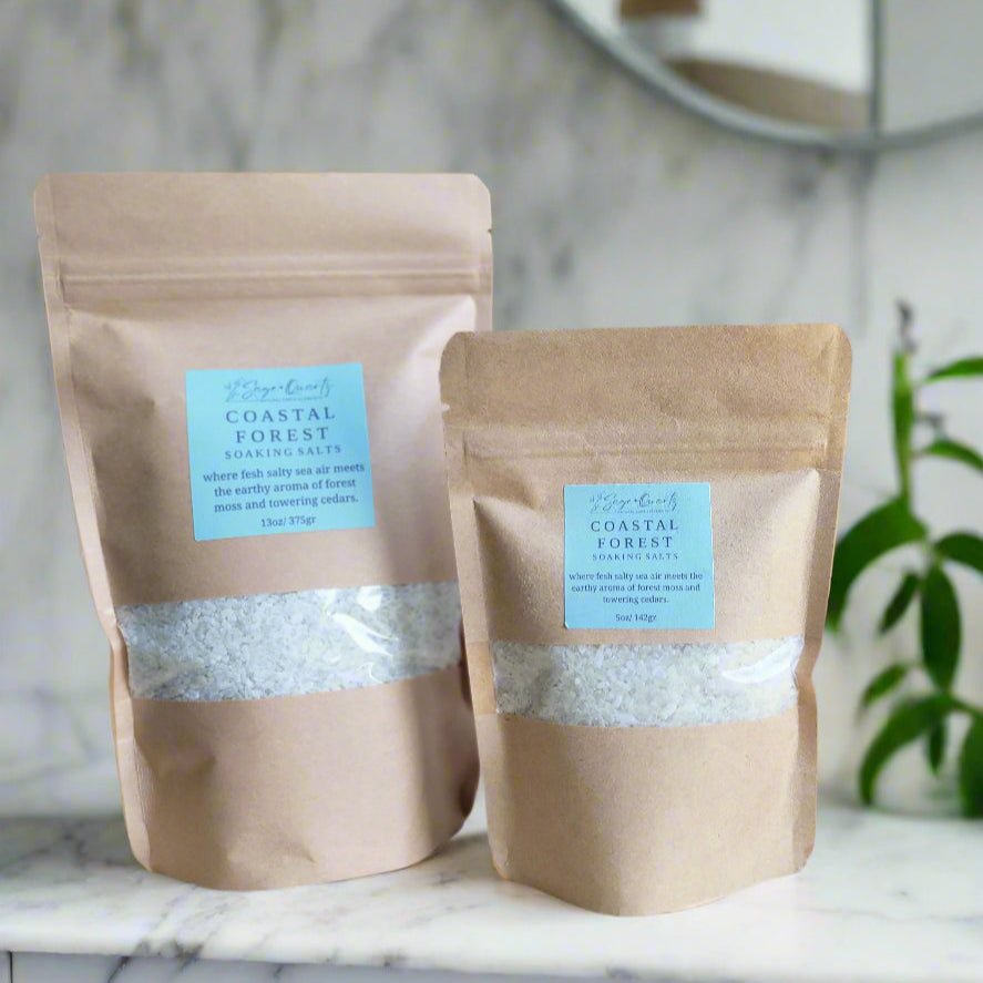 Two brown paper packages with blue labels on a wooden surface.